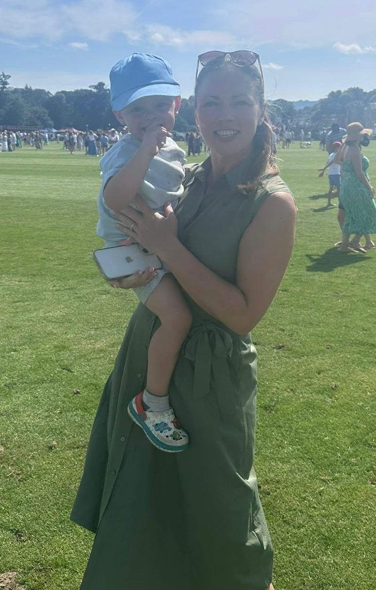 Niamh holding her grandson at a summer fair